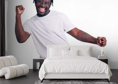 Young african american man with braids wearing casual white tshirt dancing happy and cheerful, smiling moving casual and confident listening to music Wall mural