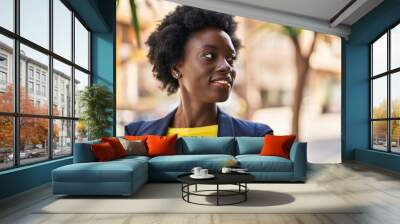 Young african american woman business executive smiling confident at street Wall mural