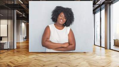 Young african american woman over grey grunge wall happy face smiling with crossed arms looking at the camera. Positive person. Wall mural