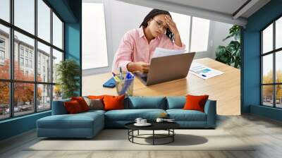 Young african american woman stressed working at office Wall mural