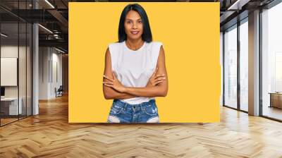 Young african american woman wearing casual clothes happy face smiling with crossed arms looking at the camera. positive person. Wall mural