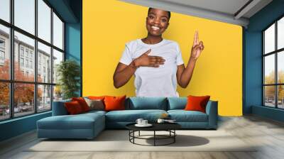 Young african american woman wearing casual white t shirt smiling swearing with hand on chest and fingers up, making a loyalty promise oath Wall mural