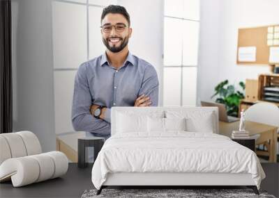 Young arab man smiling confident standing with arms crossed gesture at office Wall mural