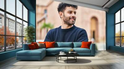 Young arab man smiling confident standing with arms crossed gesture at street Wall mural