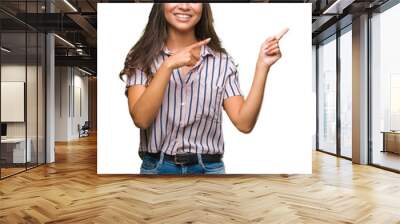 Young beautiful arab woman over isolated background smiling and looking at the camera pointing with two hands and fingers to the side. Wall mural