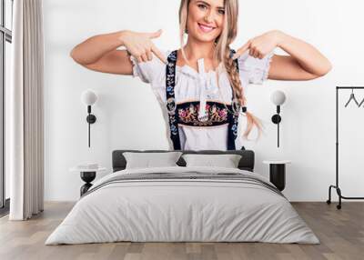 Young beautiful blonde woman wearing oktoberfest dress looking confident with smile on face, pointing oneself with fingers proud and happy. Wall mural