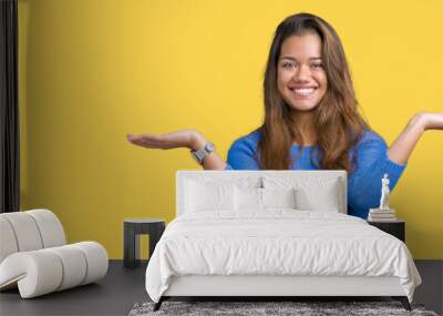 young beautiful brunette woman wearing blue sweater over isolated background smiling showing both ha Wall mural