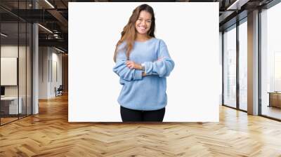 Young beautiful brunette woman wearing blue winter sweater over isolated background happy face smiling with crossed arms looking at the camera. Positive person. Wall mural