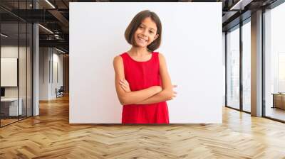 Young beautiful child girl wearing red casual dress standing over isolated white background happy face smiling with crossed arms looking at the camera. Positive person. Wall mural