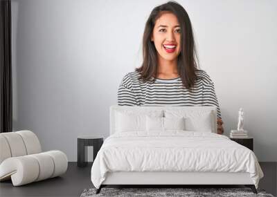 Young beautiful chinese woman wearing striped t-shirt standing over isolated white background happy face smiling with crossed arms looking at the camera. Positive person. Wall mural