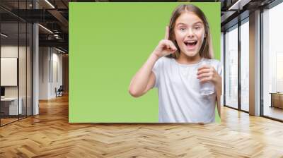 Young beautiful girl drinking glass of water over isolated background surprised with an idea or question pointing finger with happy face, number one Wall mural