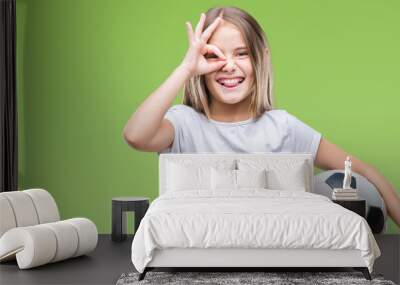 young beautiful girl holding soccer football ball over isolated background with happy face smiling d Wall mural