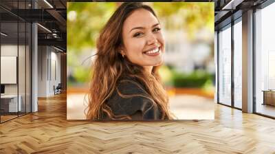 Young beautiful hispanic woman smiling confident standing at park Wall mural