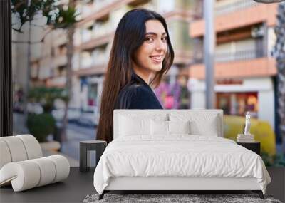 Young beautiful hispanic woman smiling confident standing at street Wall mural