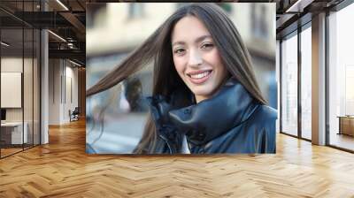 Young beautiful hispanic woman smiling confident standing at street Wall mural