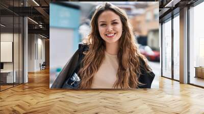 Young beautiful hispanic woman smiling confident standing at street Wall mural