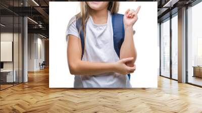 Young beautiful smart student girl wearing backpack over isolated background with a big smile on face, pointing with hand and finger to the side looking at the camera. Wall mural