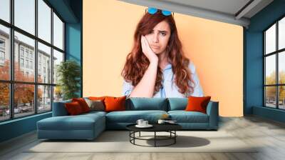 Young beautiful woman wearing casual clothes and sunglasses thinking looking tired and bored with depression problems with crossed arms. Wall mural