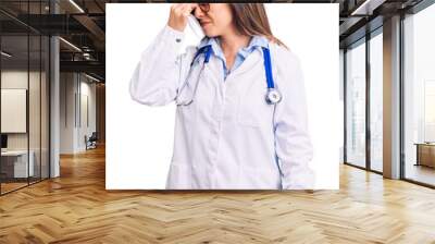 Young beautiful woman wearing doctor stethoscope and glasses tired rubbing nose and eyes feeling fatigue and headache. stress and frustration concept. Wall mural