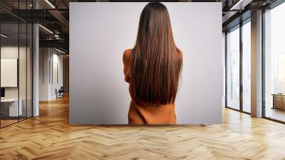 Young beautiful woman with blue eyes wearing casual sweater standing over white background standing backwards looking away with crossed arms Wall mural