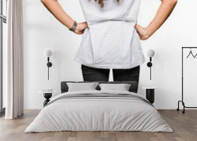 Young beautiful woman with curly hair wearing white t-shirt standing backwards looking away with arms on body Wall mural