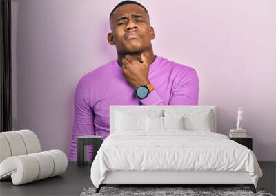 Young black man wearing casual pink sweater touching painful neck, sore throat for flu, clod and infection Wall mural