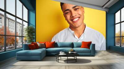 Young brazilian businessman wearing elegant shirt standing over isolated yellow background with a happy face standing and smiling with a confident smile showing teeth Wall mural