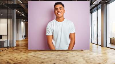 Young brazilian man wearing t-shirt standing over isolated pink background with a happy and cool smile on face. Lucky person. Wall mural