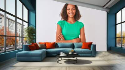 Young brazilian woman wearing green t-shirt standing over isolated white background happy face smiling with crossed arms looking at the camera. Positive person. Wall mural