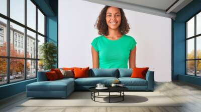 Young brazilian woman wearing green t-shirt standing over isolated white background with a happy and cool smile on face. Lucky person. Wall mural