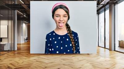 Young brunette girl wearing elegant look sticking tongue out happy with funny expression. emotion concept. Wall mural