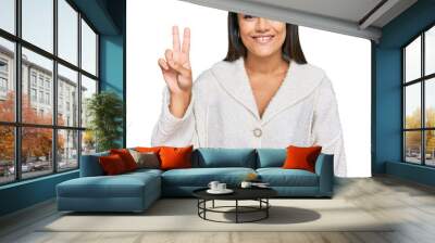 Young brunette woman wearing casual clothes showing and pointing up with fingers number two while smiling confident and happy. Wall mural