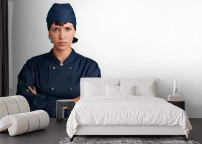 Young brunette woman with short hair wearing professional cook uniform skeptic and nervous, disapproving expression on face with crossed arms. negative person. Wall mural