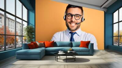 Young business operator man wearing customer service headset from call center happy face smiling with crossed arms looking at the camera. Positive person. Wall mural