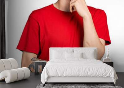 Young caucasian boy with ears dilation wearing casual red t shirt thinking concentrated about doubt with finger on chin and looking up wondering Wall mural