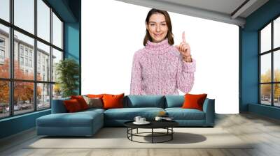 Young caucasian girl wearing wool winter sweater showing and pointing up with finger number one while smiling confident and happy. Wall mural