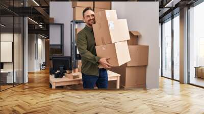 Young caucasian man ecommerce business worker holding packages at office Wall mural