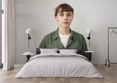 Young caucasian woman standing with serious expression over isolated white background Wall mural