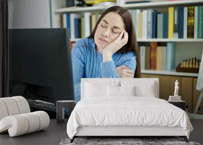 Young caucasian woman student tired sleeping on desk at library university Wall mural