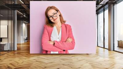 Young caucasian woman wearing business style and glasses happy face smiling with crossed arms looking at the camera. positive person. Wall mural