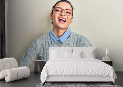 Young caucasian woman wearing casual clothes and glasses smiling and laughing hard out loud because funny crazy joke with hands on body. Wall mural