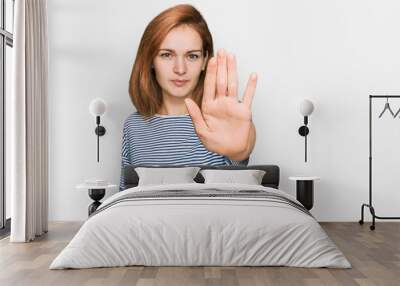 Young caucasian woman wearing casual clothes doing stop sing with palm of the hand. warning expression with negative and serious gesture on the face. Wall mural