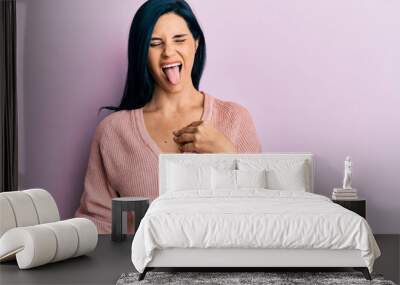 Young caucasian woman wearing casual clothes sticking tongue out happy with funny expression. emotion concept. Wall mural