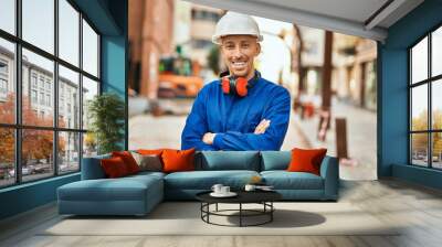 Young caucasian worker smiling happy wearing uniform at the city. Wall mural