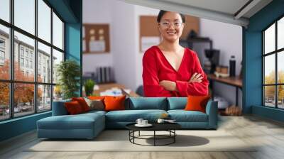 Young chinese woman business worker smiling confident standing with arms crossed gesture at office Wall mural