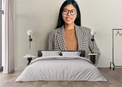 Young chinese woman wearing business style and glasses with a happy and cool smile on face. lucky person. Wall mural