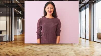 Young chinese woman wearing purple sweater standing over isolated pink background with a happy and cool smile on face. Lucky person. Wall mural