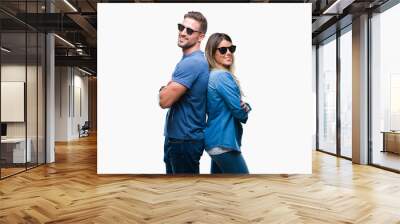 Young couple in love wearing sunglasses over isolated background happy face smiling with crossed arms looking at the camera. Positive person. Wall mural