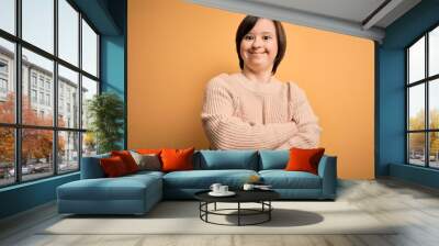 Young down syndrome woman wearing casual sweater over yellow background happy face smiling with crossed arms looking at the camera. Positive person. Wall mural