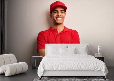 Young handsome african american man wearing casual polo and cap over red background happy face smiling with crossed arms looking at the camera. Positive person. Wall mural